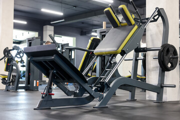 Leg press machine on floor in gym. Sport equipment