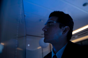 Two software developers collaborating at night, focusing on code review and debugging process on a computer screen, representing teamwork, innovation, and modern software development workflow.