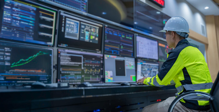Engineer working at control room, Manager control system, Technician man monitoring program from a lot of monitor.
Specialist observes analytics dashboard,operator inspects digital interface