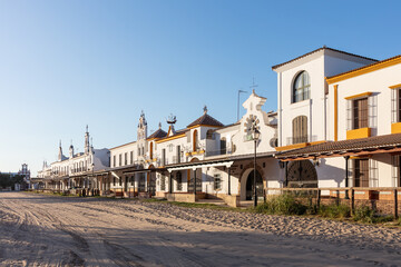 Naklejka premium El Rocio, Sevilla, Andalusia, Spain. 28 August 2025. Traditional houses and sandy square in El Rocio