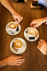 Close-up of a coffee cup on table in modern cafe, cozy and relaxing atmosphere, casual lifestyle moment.