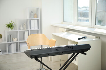 Modern electric piano and chair at home
