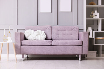Comfortable gray sofa with cushions indoors. Interior design