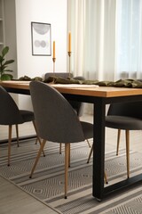 Decorated wooden table with chairs in dining room