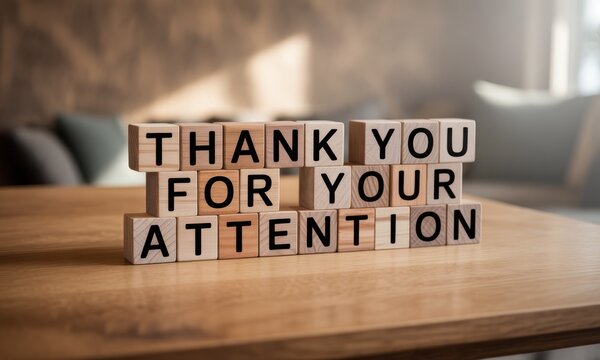 Wooden blocks spelling "Thank You For Your Attention" on a table