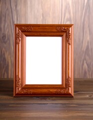 Empty light brown wooden picture frame on a dark wooden surface