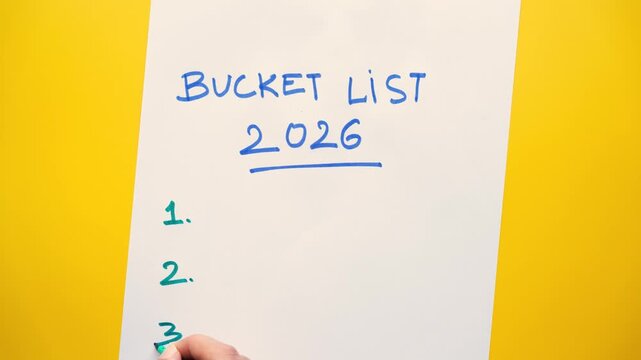 Bucket list 2026 on white paper background for travel goals, Euro trip, Northern lights, Vietnam trip, 2026 travel goals concept stock video