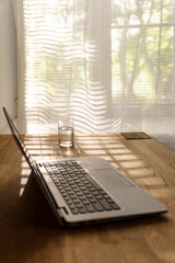 Cozy home office aesthetic with warm brown table and laptop, background with copy space
