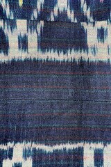 Handwoven ikat textile featuring colorful geometric patterns. Perfect for backgrounds, fashion, interior design, and cultural themes.