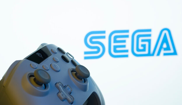 Dhaka, Bangladesh- 13 Sep 2025: A close-up of a gamepad with the Sega seen on screen in the background.