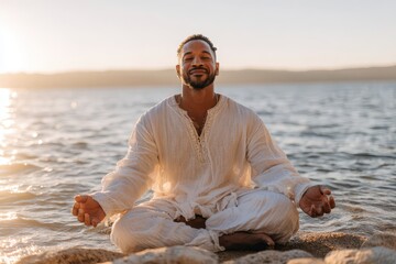 A serene African American man practices meditation at sunset by the tranquil lake, finding inner peace and balance in nature's beauty, wearing comfortable white clothing.