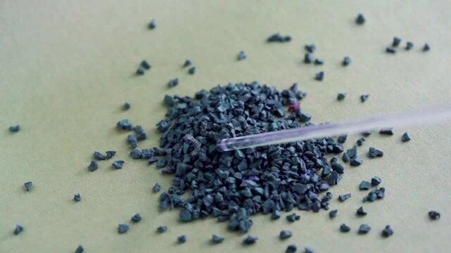 EPDM rubber granules . Colored Rubber Granules on green background