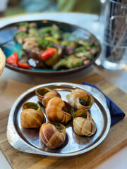 Snails with pesto sauce in a French restaurant. French national cuisine