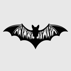 Silhouette of a bat with a forest landscape inside its wings