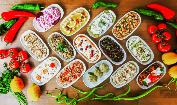 Delicious meat kebab with fresh vegetable salad served with variety of Turkish dishes and appetizers. Top view of assorted Turkish food and meze, tasty and healthy Mediterranean cuisine. Top view.