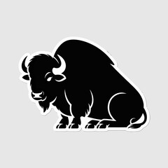 Silhouette of a powerful bison sitting on a plain background