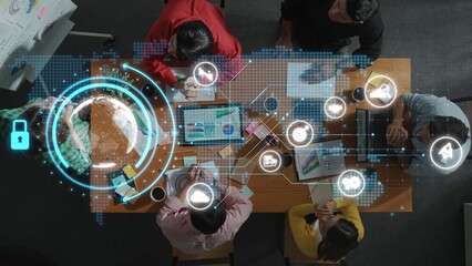 A dynamic business team collaborates with advanced digital technology in a modern office setting, analyzing data and developing strategies while fostering innovation and teamwork. Raster