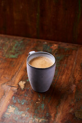 Cup of coffee on rustic wooden background. Soft focus. Copy space	