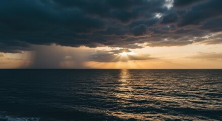 Dramatic sunset over the ocean, with stormy clouds