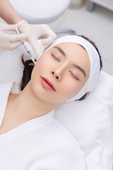 Woman Receiving Botox Injection. Dermal Filler Treatment. Cosmetic Injection Procedure at a Beauty Clinic.