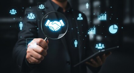 Businessman holding a magnifying glass over a handshake icon, symbolizing partnership and business growth