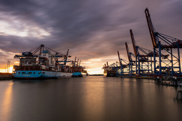 The magnificent Waltershofer Damm container port at sunset with its huge container ships.