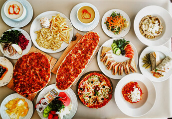 Delicious meat kebab with fresh vegetable salad served with variety of Turkish dishes and appetizers. Top view of assorted Turkish food and meze, tasty and healthy Mediterranean cuisine. Top view.