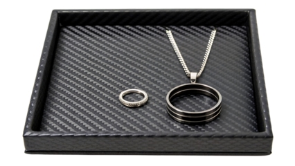Men s ring and necklace set in a black tray isolated on transparent background