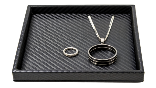 Men s ring and necklace set in a black tray isolated on transparent background