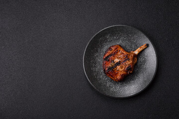 Steak, beef or pork on the bone, meat cooked on the grill with rosemary. Steak on the bone