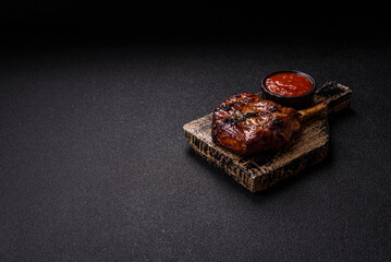 Steak, beef or pork on the bone, meat cooked on the grill with rosemary. Steak on the bone