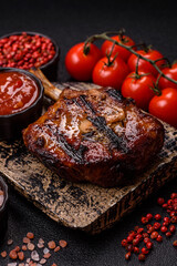 Steak, beef or pork on the bone, meat cooked on the grill with rosemary. Steak on the bone