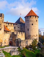 Ancient stone castle, walls and towers against a clear sky