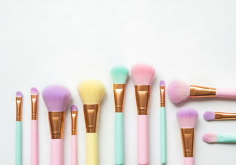 Naklejka premium Pastel makeup brushes with gold accents pastel colors