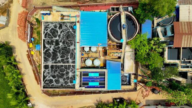 Modern Wastewater Treatment Facility with Aeration Tanks Inside Bangladeshi Manufacturing Area top down Aerial view