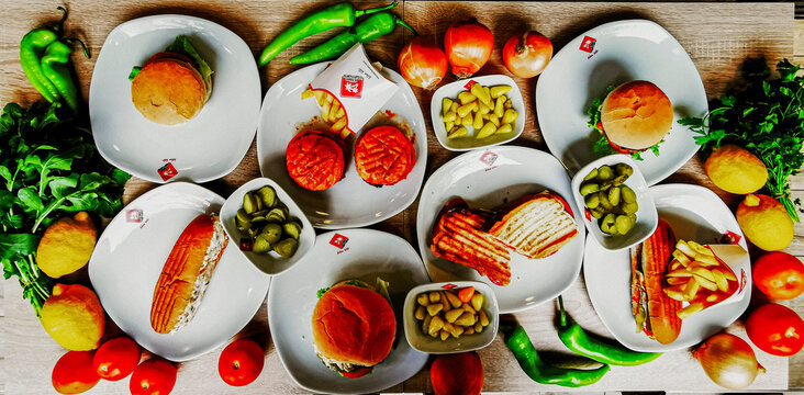 Delicious meat kebab with fresh vegetable salad served with variety of Turkish dishes and appetizers. Top view of assorted Turkish food and meze, tasty and healthy Mediterranean cuisine. Top view. - Powered by Adobe