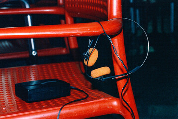 headphones and compact player on a red chair, 35mm