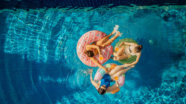 Pool party drone overhead photo, best girlfriends floating in water