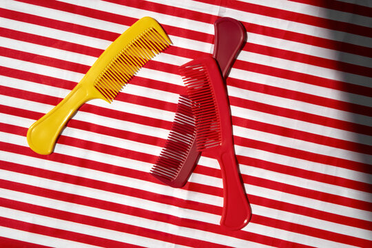 Still life with Colorful Combs on a Striped Background.
