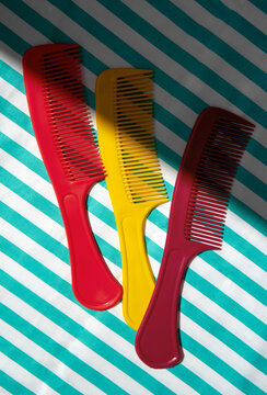 Still life with Colorful Combs on a Striped Background.