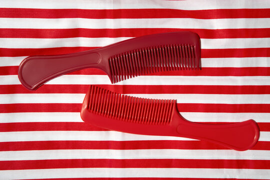 Still life with Colorful Combs on a Striped Background.