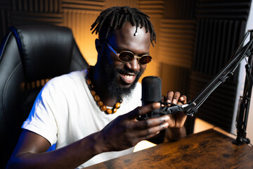 Content creator preparing his microphone, getting ready to record