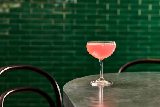 Pink Cocktail on Modern Urban Table &ndash; Contemporary Lifestyle Aesthetic