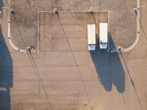 Two Semi Trucks Parking Lot Aerial View Shadows
