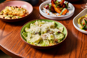 Fresh Caesar Salad and Shared Plates in a Cozy Bistro