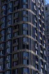 Modern building under construction with scaffolding and reflective windows