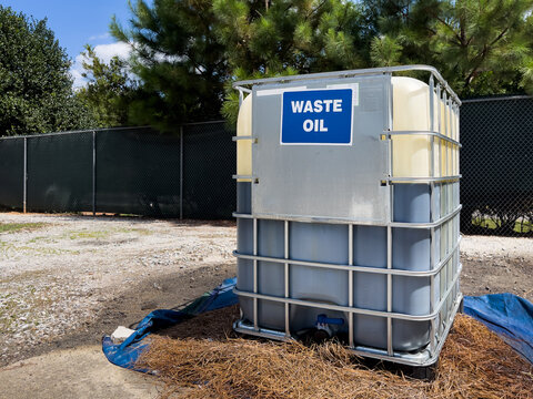 Waste oil recycling tank for used motor oil disposal at local trash dump recycle center.