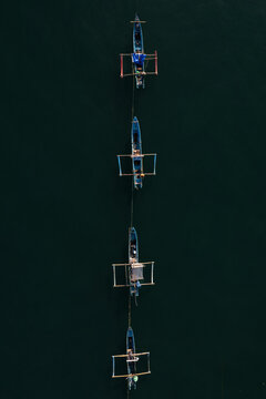 Aerial View of Traditional Javanese Outrigger Boats Moored in Line. 