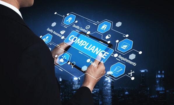 A businessman in a suit uses a tablet to navigate compliance strategies, showcasing various icons related to quality control and policy in a modern digital setting. Tessel