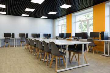 Modern computer lab space with bright walls and ergonomic seating for efficient learning